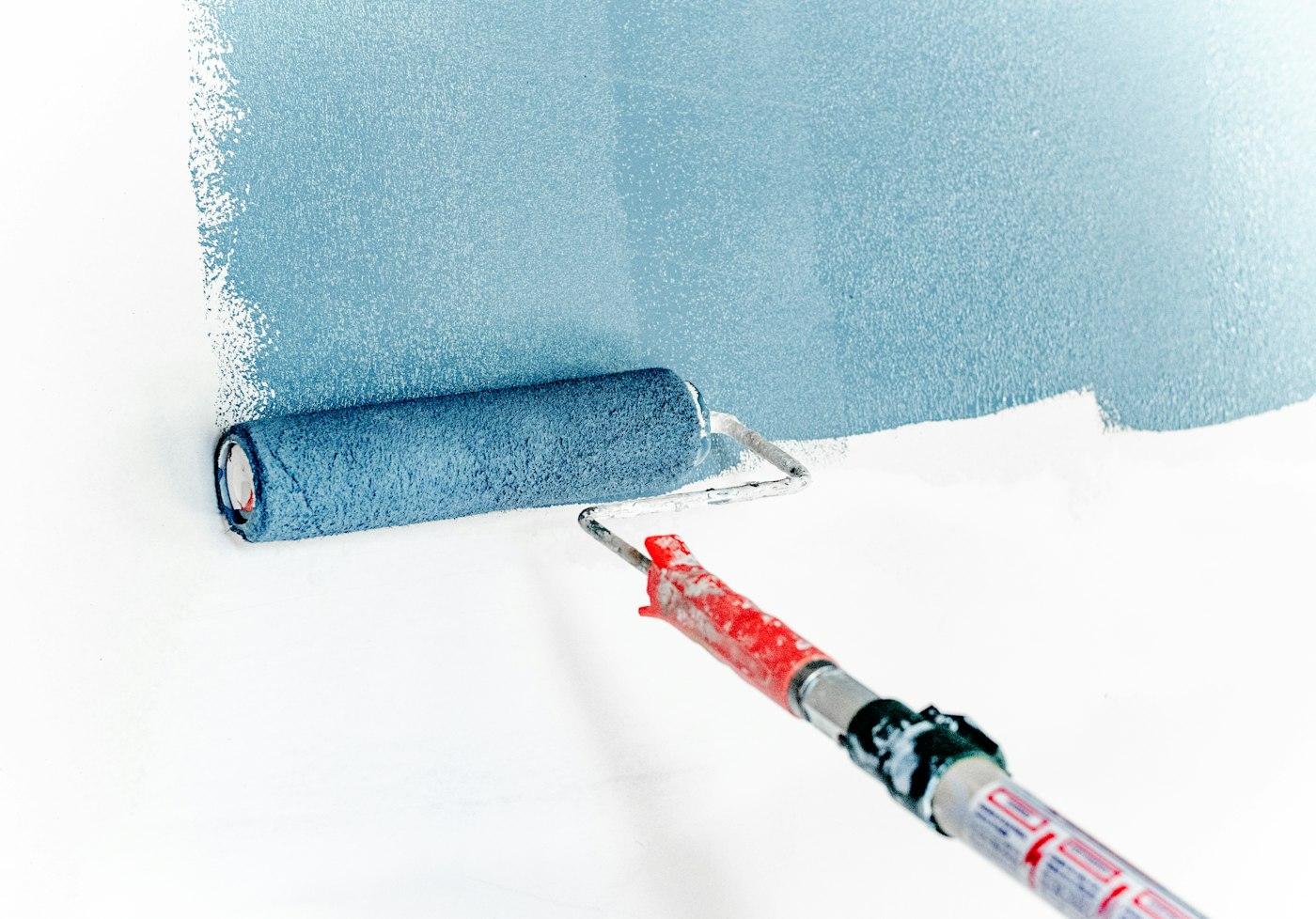 A wall being painted with a roller